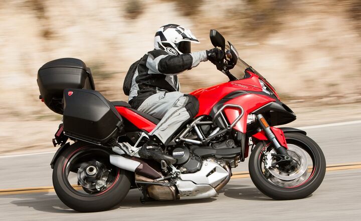 2014 ducati multistrada granturismo review, A more upright seating position by virtue of 20mm taller handlebar risers doesn t hamper the GT s cornering prowess Note the included crash bar and fog light there s a matching set on the opposite side