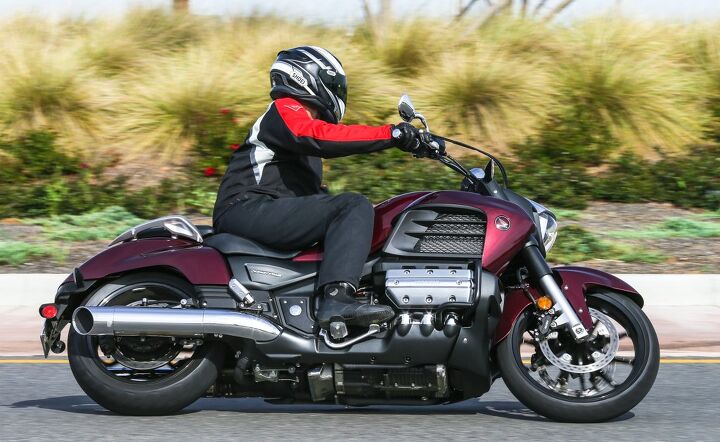 2014 honda gold wing valkyrie review first ride, The relocated pegs combine with the 19 inch front and 17 inch rear wheels to give the 2014 Valkyrie some pretty impressive ground clearance The Dark Red Metallic gives a more stately appearance