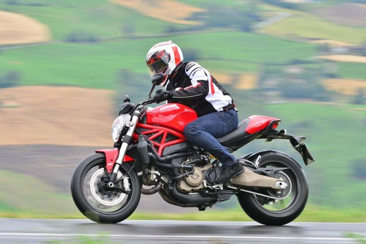 2015 ducati monster 821 review first ride, Our rainy ride revealed the rubber footpegs become very slippery when wet and the license plate bracket is no excuse for a fender rear tire spray covered the back of the bike and left a skunk stripe down the back of my Dainese jacket