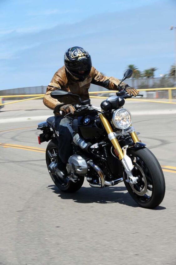 2014 bmw r ninet first ride review, Note the full fork extension after just a mild twist of the Boxer s throttle It boasts strong and immediate power at every point on the rev counter Roll on acceleration at highway speeds will beat nearly any bike you can name