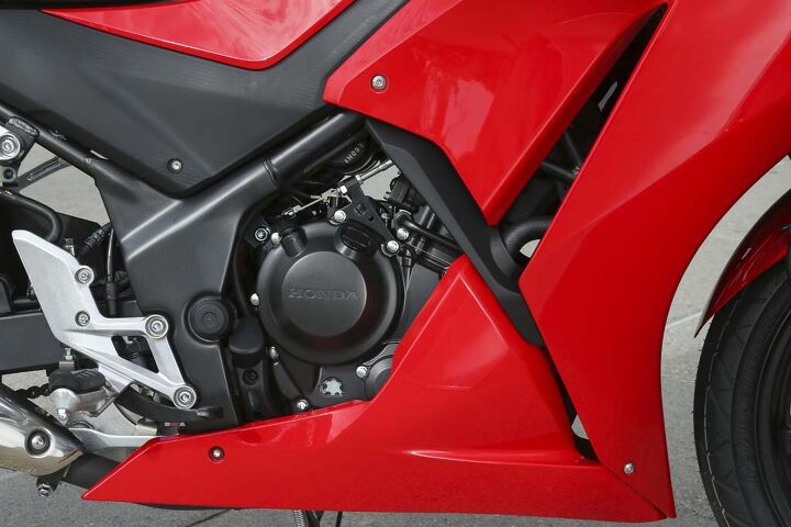 2015 honda cbr300r first ride review, Underneath that revised bodywork lies the same basic Single from the CBR250R A longer stroke turns the 249cc Thumper into a 286cc Thumper