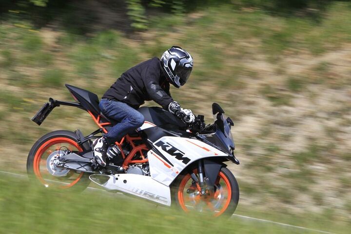 2015 ktm rc390 first ride review video, Duke at 5 foot 8 fits the RC390 well but a 6 foot 3 rider at the launch said he also felt comfortable with the ergonomics Note how the stainless steel exhaust system is almost totally hidden inside the bellypan bodywork