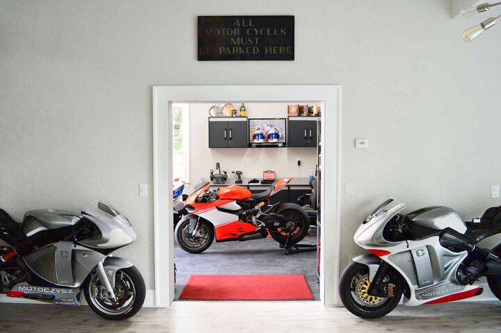 motoczysz the story of america s ultimate motorcycle, While we don t have any pictures of the home he designed for Cindy Crawford here s a glimpse at the entryway to Michael Czysz s garage Original C1 prototype on the left later version on the right Ducati Superleggera in the middle Sign reads All Motorcycles Must Be Parked Here