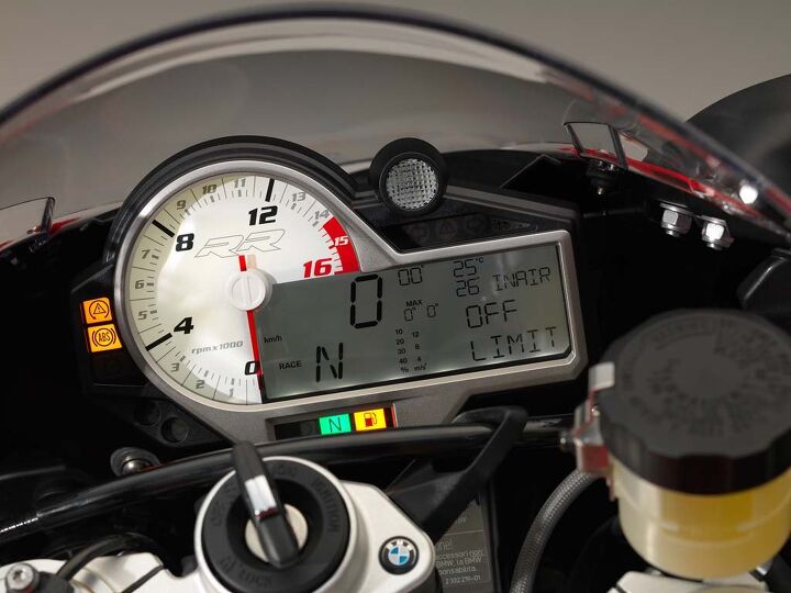 2015 bmw s1000rr first ride review video, Instrumentation is similar to the old model with an easy to read analog tach centrally placed shift indicator and digital LCD screen There s a lot of information in that small screen but like the rest of the bike the display and its contents are adjustable