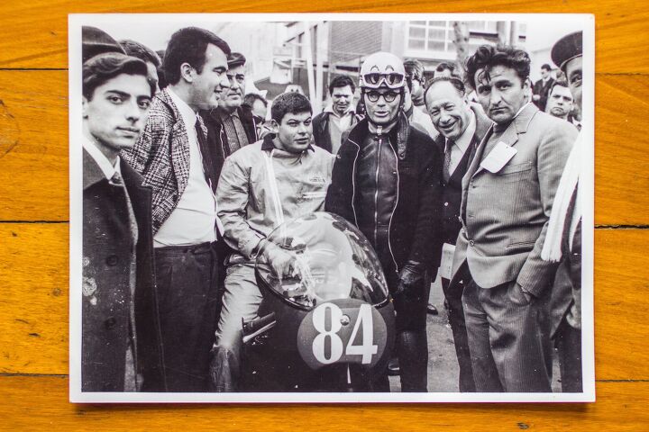 50 years in the grand prix paddock, Cecchini sitting on bike and Pasolini wearing helmet