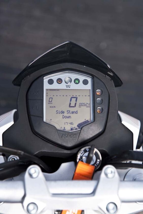 2015 ktm 390 duke first ride review video, Comprehensive instrumentation includes easy to read digital speedo and a gear position indicator fuel economy info a fuel gauge temperature levels and a programmable shift light The tiny numerals on the tiny bar graph tach frustrate