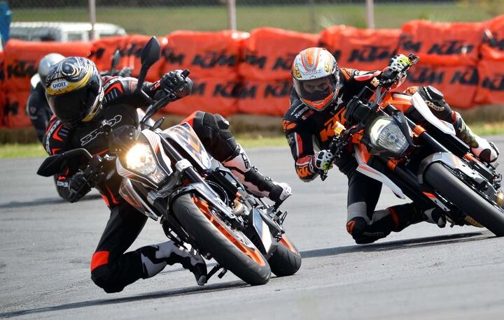 2015 ktm 390 duke first ride review video, Former Grand Prix racer Jeremy McWilliams aboard a 690 Duke tries in vain to get around Duke on a 390 Duke Well a Duke can dream