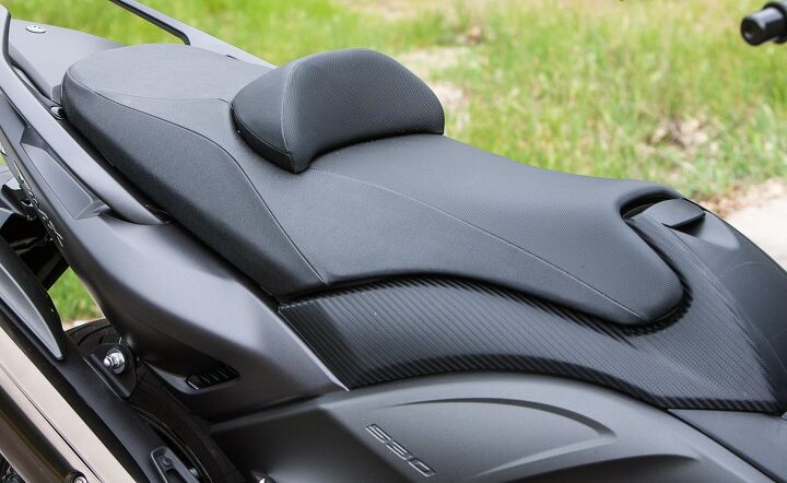 2015 yamaha tmax review, Don t let that taper at the front of the saddle fool you The TMAX gets considerably wider below the seat making for a long reach to the ground if you own a short inseam The bolster is adjustable though