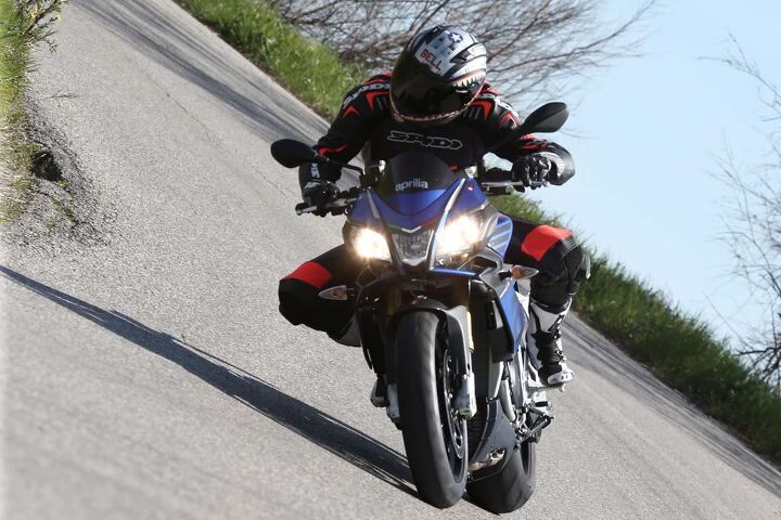 2016 aprilia tuono v4 1100 rr first ride review, A slightly wider upper fairing deflects more wind around a Tuono 1100 rider Headlights are new and 3 lbs lighter than the previous generation while an LED position parking light resides in the central position around the high beam lamp