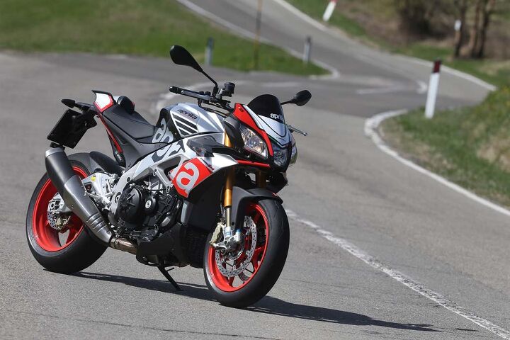 2016 aprilia tuono v4 1100 rr first ride review, For the first time Aprilia is offering a Factory version of the V 4 Tuono seen here in its Superpole graphic Retailing for a 2 200 premium over the 14 799 RR it includes Ohlins suspension and steering damper aluminum rather than the RR s steel front brake rotor flanges a wider 200 55 17 rear tire and red wheels wheels are not the lighter forged aluminum hoops sometimes fitted to Aprilia s Factory models The 16 999 Factory is scheduled to arrive in American dealers this month a couple of months ahead of the RR