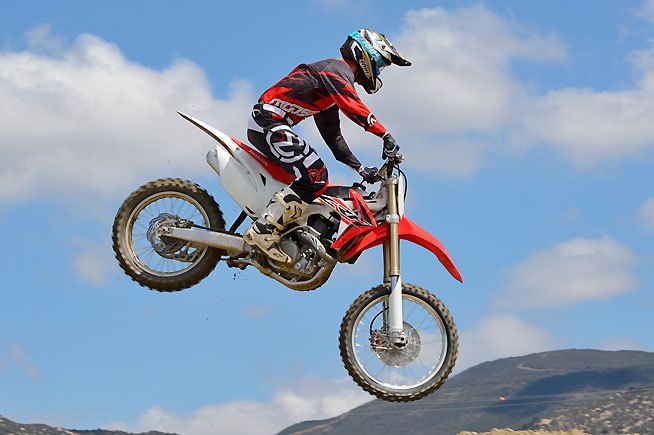 2016 honda crf450r first ride review, The CRF s front and rear suspension are harmonious whether tacking small bumps whoops or landing from big jumps Still it s interesting that Honda fits the big CRF with KYB components despite owning suspension giant Showa