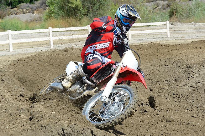 2016 honda crf450r first ride review, The CRF450R can make quick direction changes thanks to its excellent wave rotor style disc brakes and Nissin calipers When it comes to brakes the Honda more than makes up for any perceived lack of power compared to its competition with a linear feel front and rear