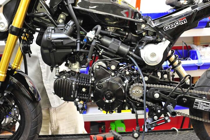 building a honda grom roadracer, With the left fairing removed we see the exposed engine airbox evap canister and associated hoses and wires We re going to clean this up