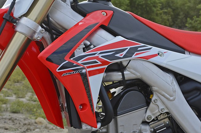 2016 honda crf250r review, If there s one thing we can t stand about the CRF2540R and CRF450R it is that their radiator shrouds and especially those black louvers that protrude just below them snag boots and kneeguards with reckless abandon during cornering The situation spoils an otherwise comfortable ergonomic layout