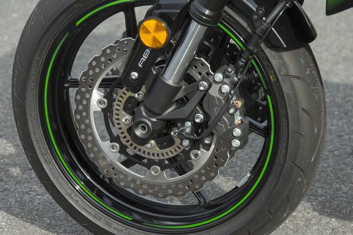 2016 kawasaki z800 abs first ride review, Petal type discs are on the smaller side at 277mm but despite the non radial caliper arrangement there are no big complaints in the Z800 s braking Note also the ABS ring the only sign of 21st century tech on this bike Dunlop Sportmax D214 tires sit front and rear in 120 70 17 and 180 55 17 sizes
