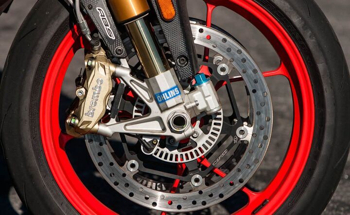 2016 aprilia tuono v4 1100 factory review, The majority of changes between the Tuono V4 1100 RR and Factory summed up in one photo The Factory gets hlins suspension and steering damper aluminum front brake rotor flanges wider 200 55 17 rear tire and red wheels