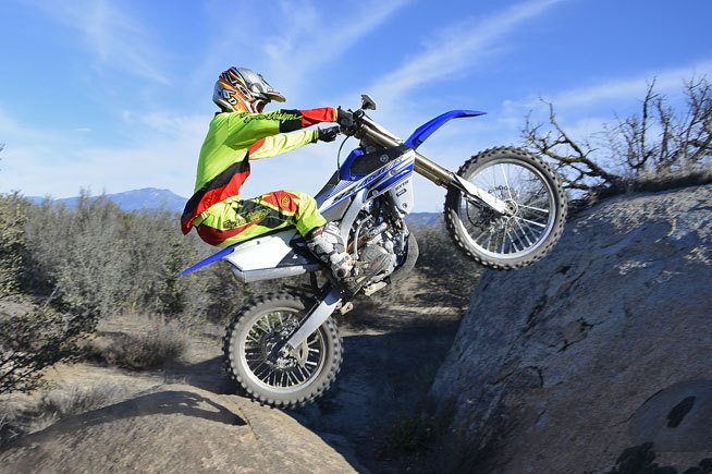 2016 yamaha yz450fx ride review, Steeper first second and third gear ratios and off road specific ECU conspire to turn the YZ450FX into a mountain goat on steroids Its low end tractability and smooth yet brawny power output can make short work of technical obstacles like this rock Test rider Nic Garvin goes for the proverbial leap in a single bound