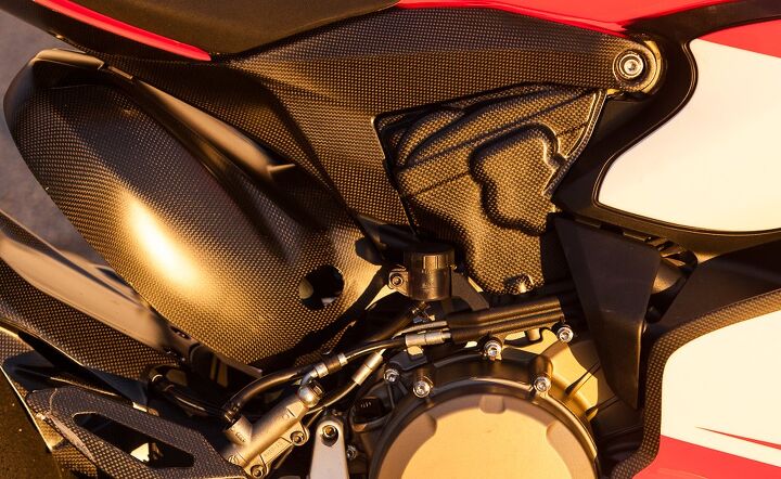 ducati panigale superleggera quick ride review video, Carbon fiber is prominently featured on the Superleggera seen here in heat shielding for the rear cylinder and its header footrest heelguard and fairing panels The carbon rear subframe supports the seat and tail structure while weighing just 2 lbs