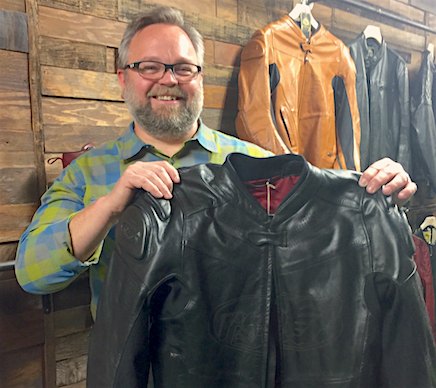 roland sands design gets technical, Bob Ketchum of Roland Sands Design proudly shows off the Zuma jacket in black Behind him is the Zuma in Timber coloring Ketchum says that RSD jackets feel like a broke in catcher s mitt because of the processing each jacket receives prior to public availability