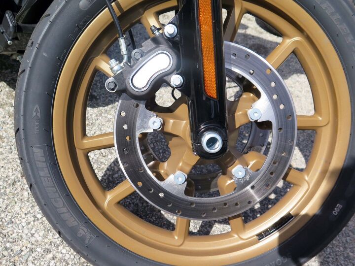 2016 harley davidson low rider s first ride review, The latest in 300mm floating discs mounted directly to the 19 inch wheel meets the latest Michelin bias ply rubber the company that invented motorcycle radials in 1984 It all works ABS is standard with the ABS sensor cleverly hidden in the wheel bearing