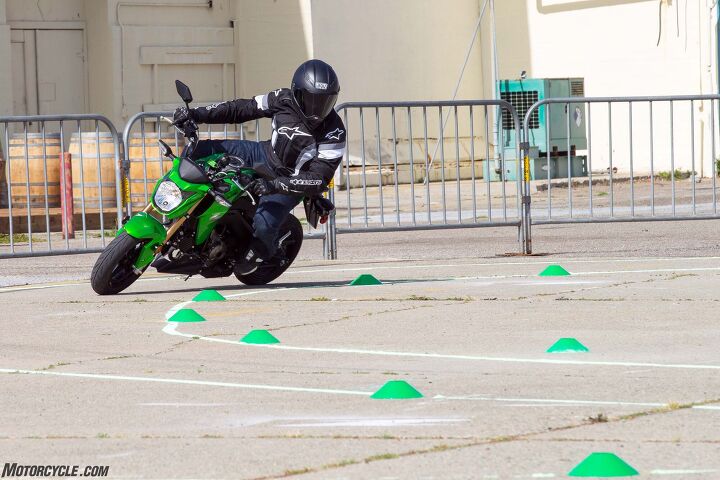 2017 kawasaki z125 pro first ride review, Hustling the Z125 through Kawi s chalk outlined course as part of the skills challenge the lawyer approved word for race was the closest thing we had to a go kart track If only we had leathers