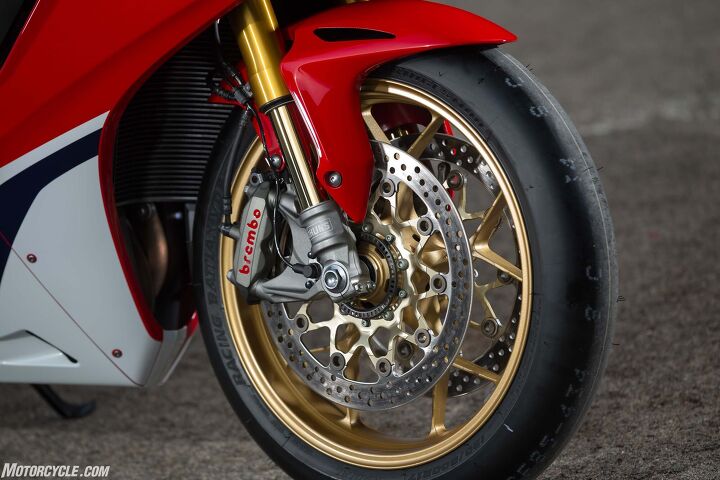 2017 honda cbr1000rr and cbr1000rr sp review, SP models get the upgraded Ohlins S EC suspension and Brembo caliper over the standard bike s Showa BPF and Tokico caliper Wheels are the same cast units between the two except standard gets black SP gold Forged wheels are saved for the limited edition SP2 race homologation version Note also the Bridgestone V02 slick tire seen here Pay no attention to it as the SP will be sold with B Stone s RS10 tire instead