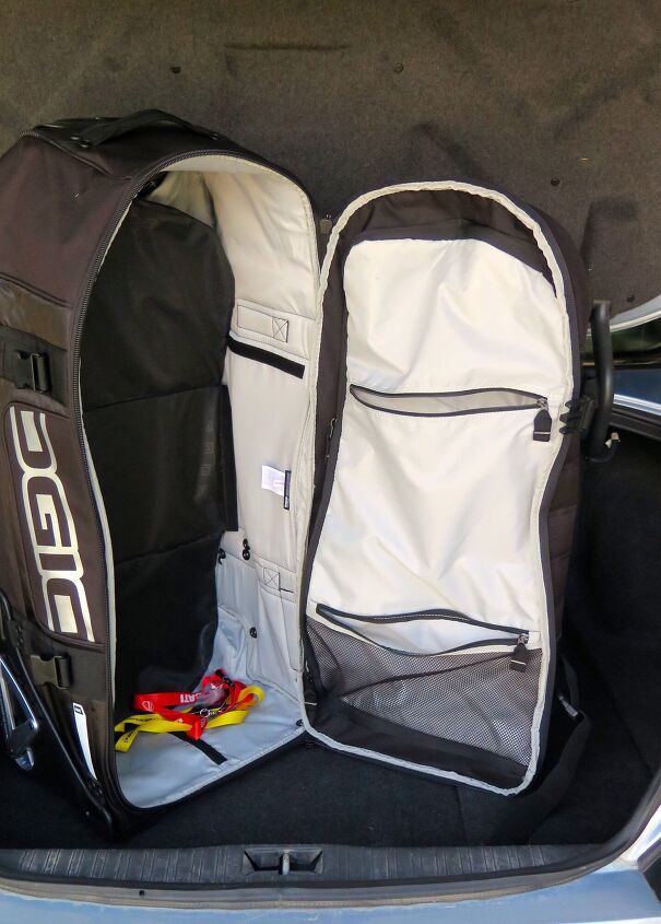 ogio rig 9800 rolling luggage bag review, There s an adjustable divider in there I never bother to adjust and the whole right side here is a big zippable compartment you can use to keep clothes separate from riding gear Padding all around maintains shape and provides protection for contents