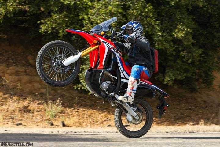 2017 honda crf250l rally review first ride, Lofting the front wheel on either the CRF250L Rally or its standard sibling requires a liberal doses of revs and a snap of the clutch It s still fun no matter which way you do it