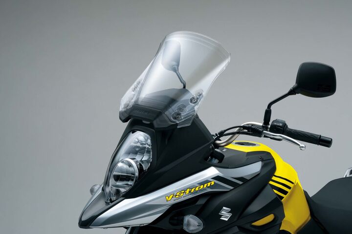 first look 2017 suzuki v strom 650 and 650xt, Cool new beak styling like the V Strom 1000 brings vertically stacked headlights and a less wall eyed confused look Four rubber nuts you can undo with your fingers give the bigger windshield three position adjustability The XT also gets hand guards though not in this Suzuki supplied photo