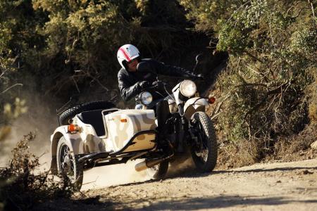 church of mo tom genuflects at the ural, Leaning to keep the sidecar planted is necessary during aggressive riding maneuvers but the poorly shaped angle of the handlebars is not conducive to comfortably performing this action