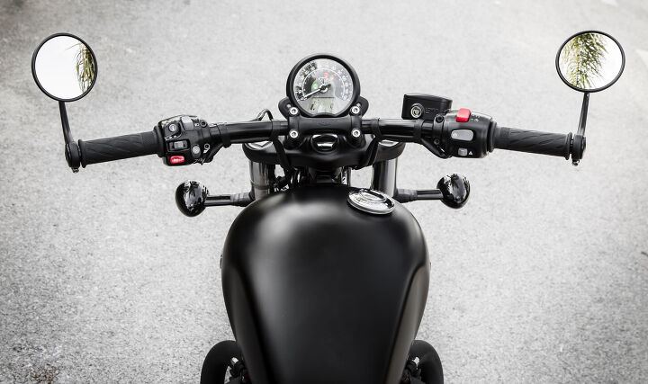 2018 triumph bonneville bobber black first ride review, A very clean and minimalist cockpit with thoughtfully placed buttons allows the rider to easily toggle turn signals riding modes and cruise control without any need to look down Though it would be nice to incorporate an always visible tachometer to the gauge instead of just a digital number read out only accessible through toggle options