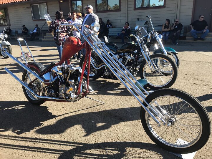 A Springer front end chopper adorned with a vibrant, artistic paint job, blending mechanical design with fine art.