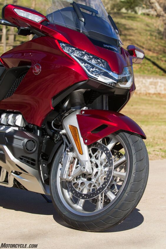 2018 honda gold wing tour review, Look closely and you ll see how tightly placed the front wheel is to the engine That s because the double wishbone fork tracks straight up and down over bumps