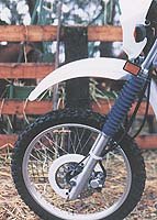 church of mo 1998 yamaha xt350, The front binder isn t the most sensitive unit on the planet Generous suspension with swoopy accordion style fork tube protectors dives under heavy braking