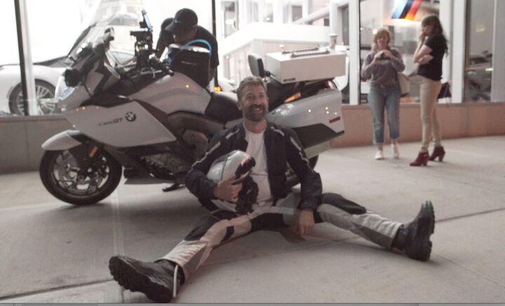 top ten motorcycle tours and tourists of all time, Carl chills while a notary public checks his odo and VIN in NYC