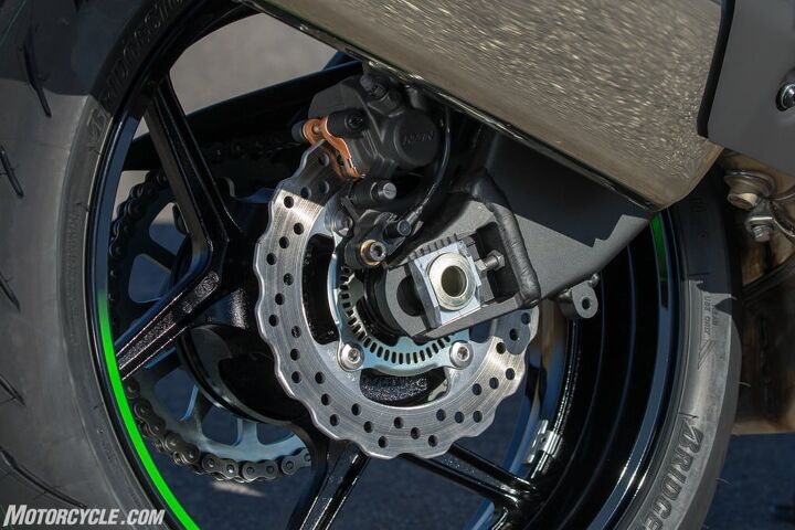 why you need abs on your next motorcycle, Modern ABS sensors are very discreet housed in a tiny bracket seen here between the caliper and the end of the swingarm The sensor reads the speed of the slotted ring inside the rotor carrier to detect lockup