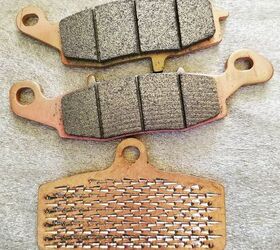 how do i choose the right brake pads, At the bottom you can see the backing plate with the metal hooks used to achieve the supremely strong mechanical bond between the backing plate and the pad material