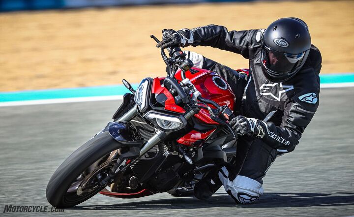 2024 triumph street triple 765 r rs review first ride, At the exit of a corner when you straighten the Street Triple up while hard on the gas the front wheel really wants to lift Charging down the straight with the TC light flashing and the front tire skimming the pavement becomes the norm as the Track mode tries to optimize the acceleration