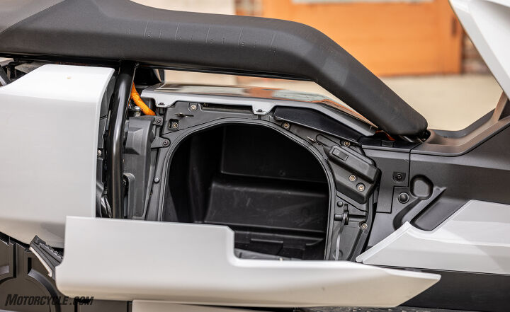 2022 bmw ce 04 scooter mini review, You can fit a lot of stuff in that compartment but it would have been nice if the empty space beneath the seat were used for more storage