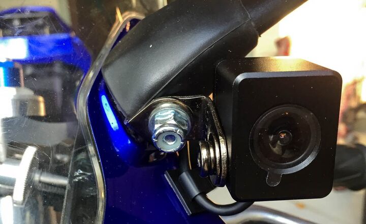 mo tested innovv k1 motorcycle camera review, In this location the Innovv camera tucks discretely up next to the mirror stalk The stick on cable holder keeps the wired tucked close to the fairing