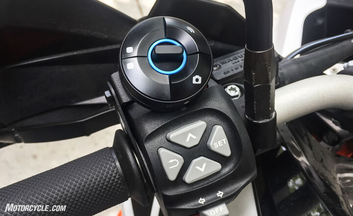 mo tested nuviz head up display review, The NUVIZ remote top can be mounted on multiple bikes via the included hardware The buttons on the left correspond with the icons on the left side of the screen The central toggle switches between screens with short flicks while long presses control the speakers volume