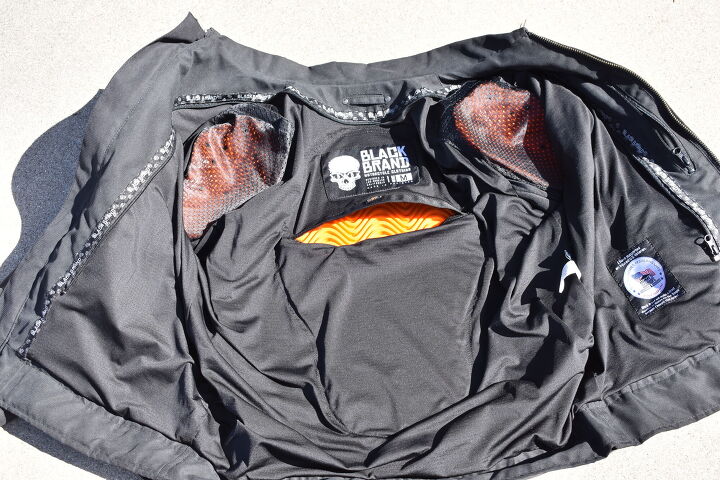 mo tested black brand street team jacket, The orange D30 armor on the shoulders elbows not shown and back is soft flexible and unobtrusive Upon impact the material instantly hardens