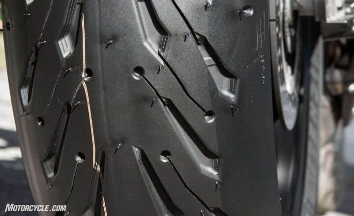 mo tested michelin road 5 tire review, The Michelin Road 5 looks like a slick when you get to the edge of the tire all in the name of improved grip Note how the two tread compounds are visible The all silica is the lighter color on the left while the all carbon black is on the right