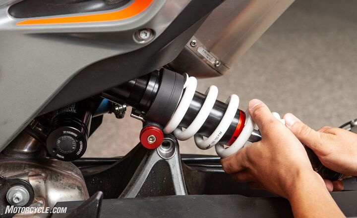 mo tested wp apex pro 6500 cartridges and 6746 shock for ktm 790 duke, As the shock slides into place we get a good view of the optional preload adjuster red knob It s hard to believe there is enough room for the reservoir in the tight quarters between the subframe spars