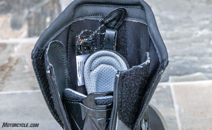 Lots of features in one photo: The drawstring for the speed lace insures a snug fit, the plate covering the Achilles tendon acts as a shoehorn, and the boot opening is adjustable thanks to the two panels on either side of the rear zipper.