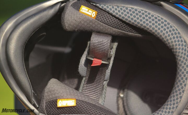 The orange emergency quick-release tabs can be pulled to easily remove the cheek pads after an unfortunate incident. The small chin curtain can also be pulled down to limit airflow from underneath the helmet.
