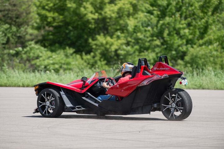 2015 polaris slingshot review first ride drive video, The rear wheel is attached to a single side swingarm Front and rear suspenders are of the non adjustable sport tuned variety Tail lights are LED