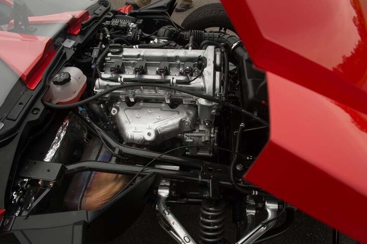 2015 polaris slingshot review first ride drive video, Not as attractive as the exposed V Twin powering the Morgan three wheeler but a helluva lot more powerful is the DOHC 2 4 liter GM Ecotec engine Entry is gained via a reverse tilting hood Polaris estimates a 26 mpg average