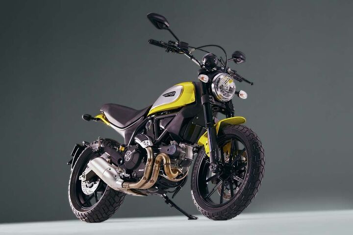 2015 ducati scrambler unveiled video, The air cooled two valve per cylinder lives on in the Scrambler Note the aluminum cam belt covers and and the attractive and hopefully effective heat shielding for the rear cylinder s header pipe