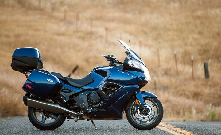 2014 heavyweight sport touring shootout k1600gt vs concours14 vs trophy se vs, If you ride in a lot of foul weather the Trophy pokes the most peaceful hole through it That single sided swingarm and standard centerstand make tire changes a breeze too